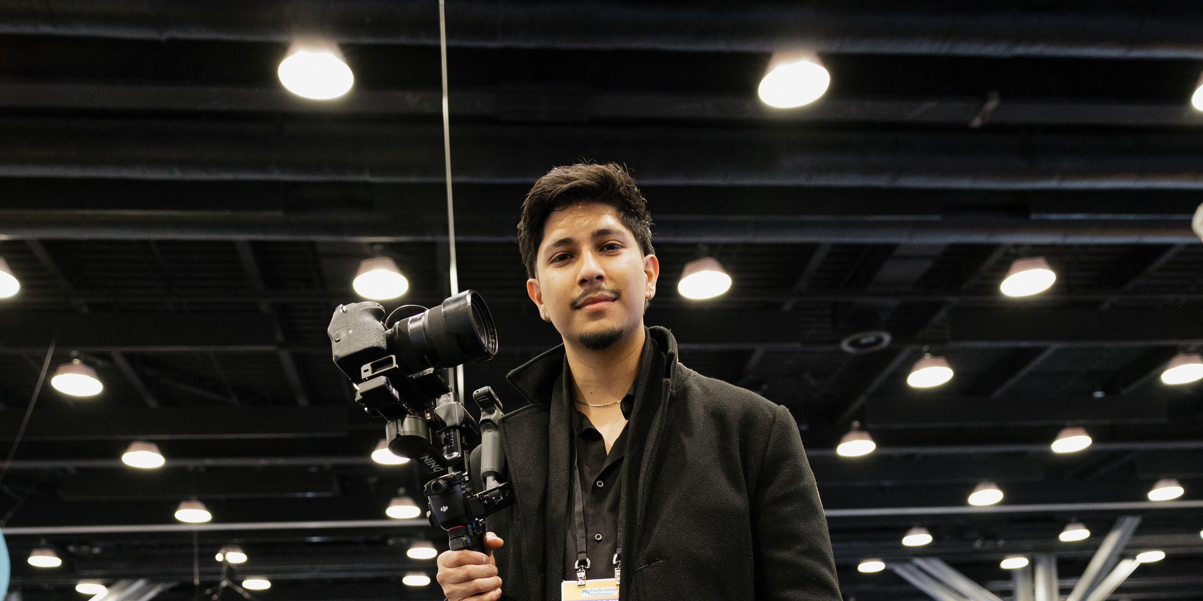 MediaNV videographer with a camera gimbal at a dental conference